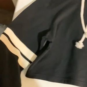 Black crop top hoodie with white strips on the side.